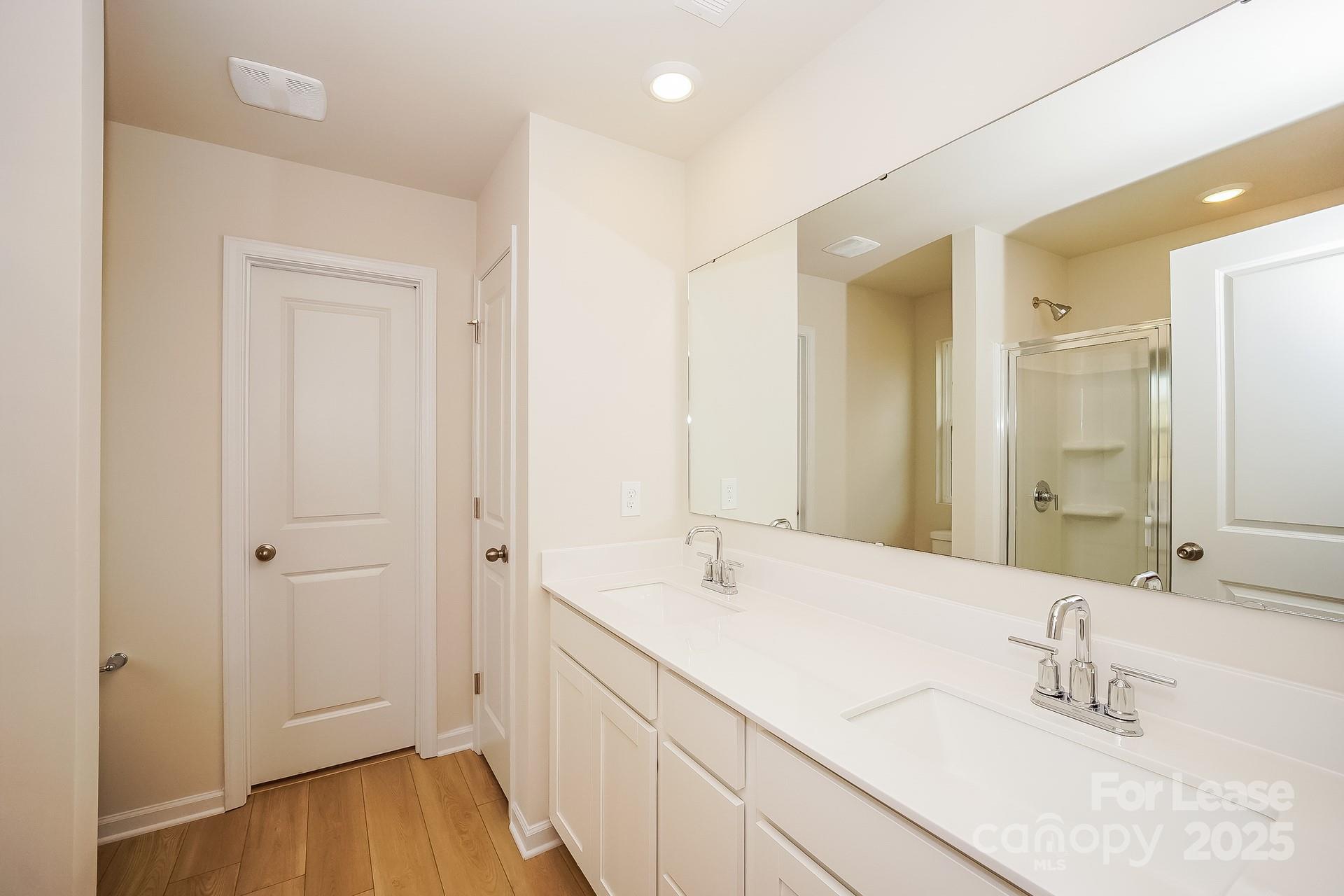 143 Arden Court Troutman, NC 28166 - Photo 13 of 18 a bathroom with a tub sink and mirror