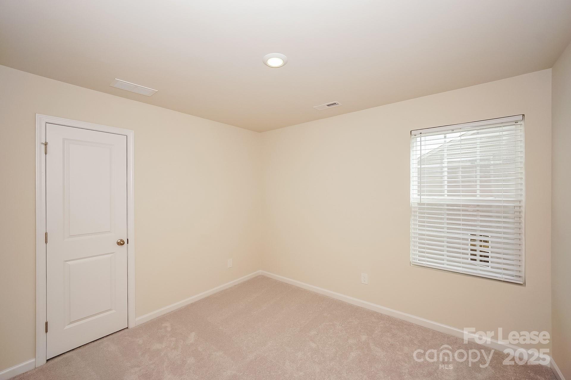 143 Arden Court Troutman, NC 28166 - Photo 14 of 18 a view of an empty room with a window