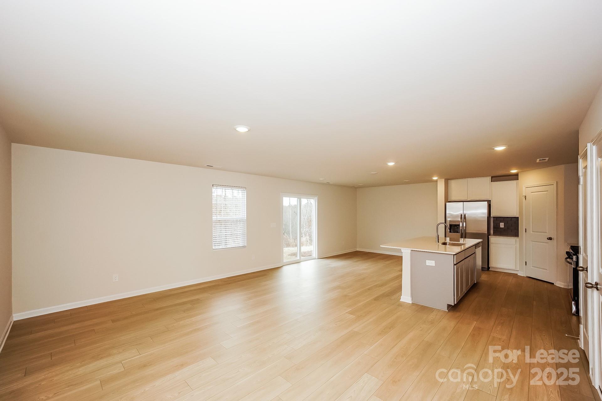 143 Arden Court Troutman, NC 28166 - Photo 7 of 18 wooden floor in kitchen and a big room with wooden floor