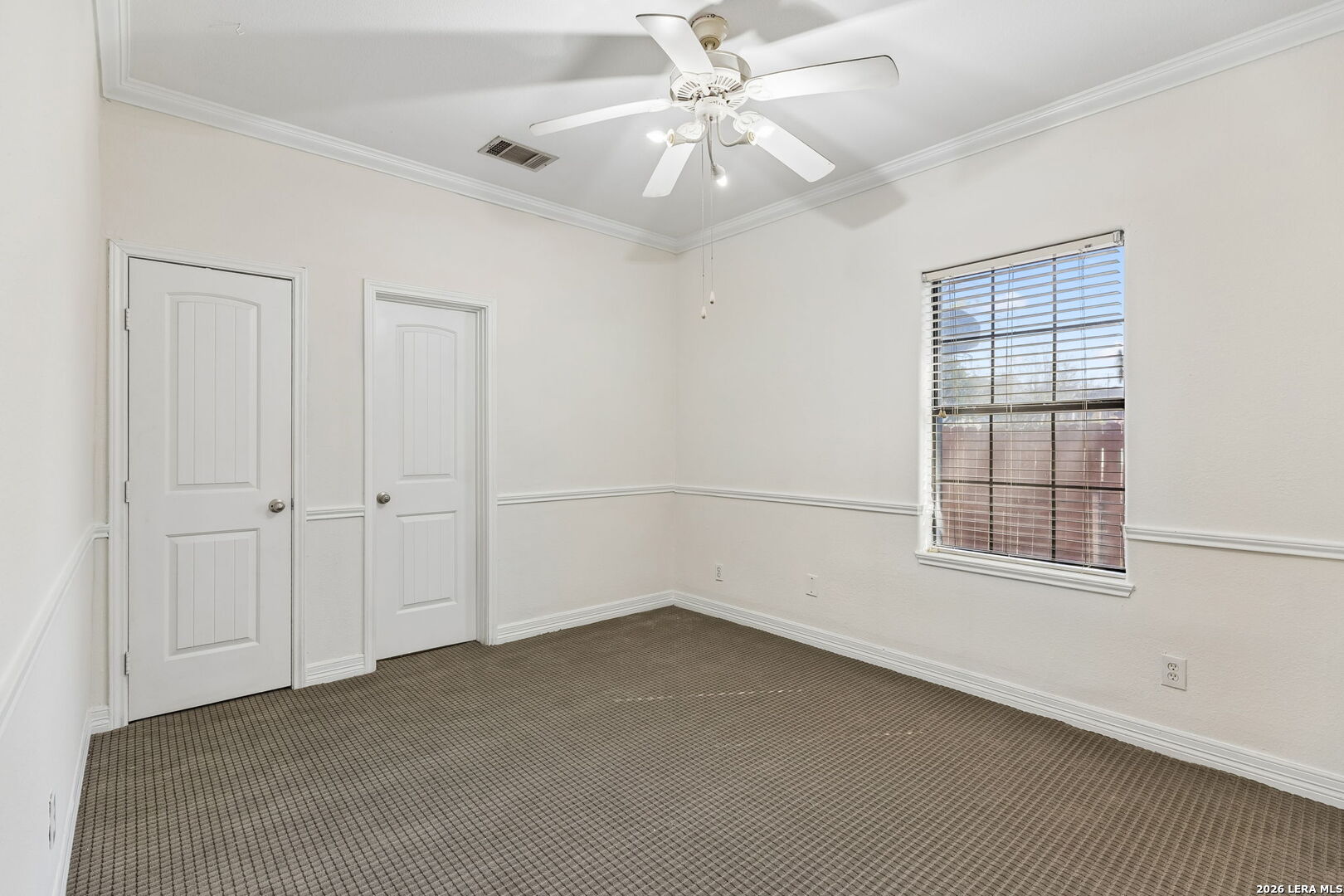 438 Rigsby Avenue San Antonio, TX 78210 - Photo 12 of 25 an empty room with chandelier fan and windows