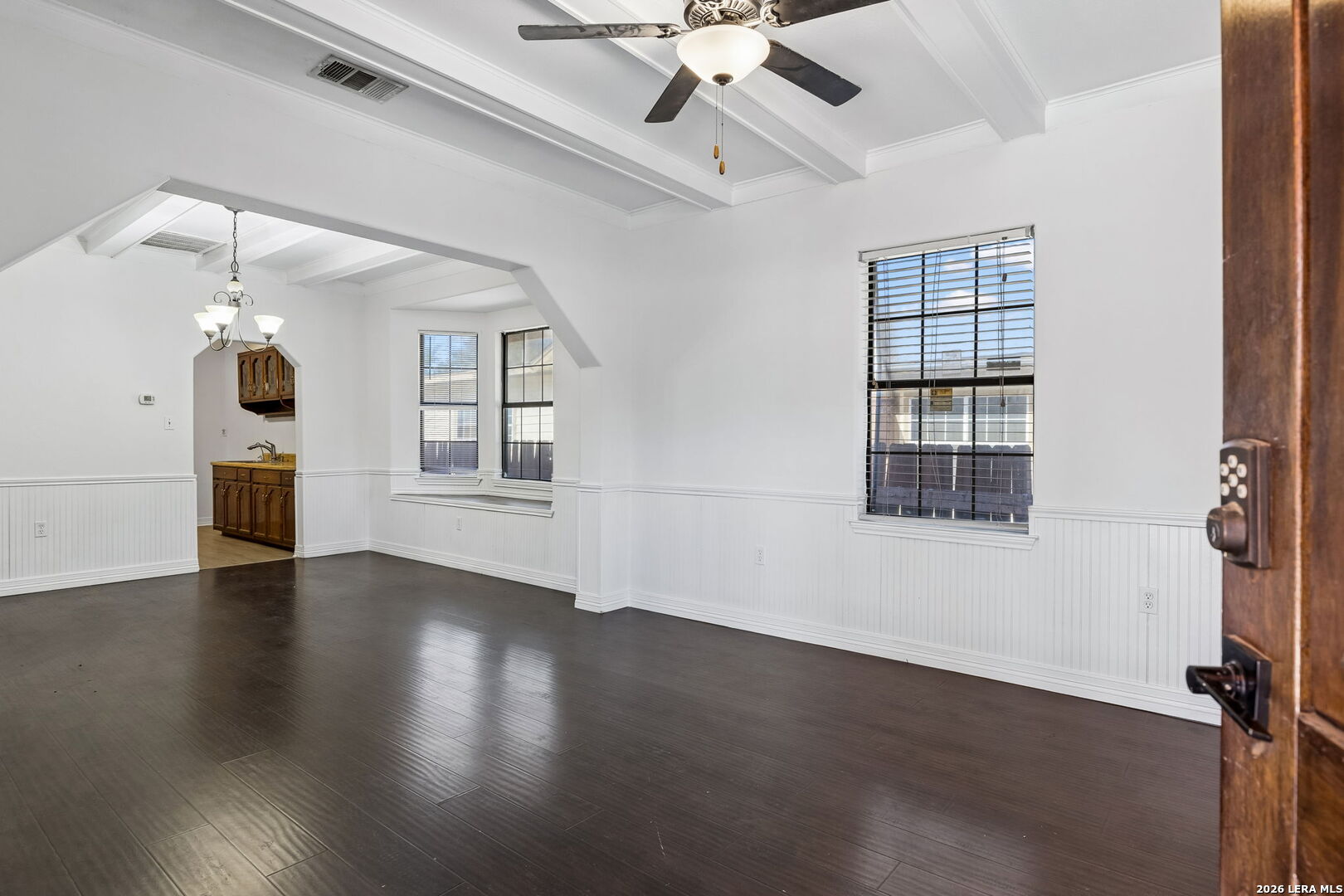 438 Rigsby Avenue San Antonio, TX 78210 - Photo 4 of 25 a view of empty room with wooden floor and fan