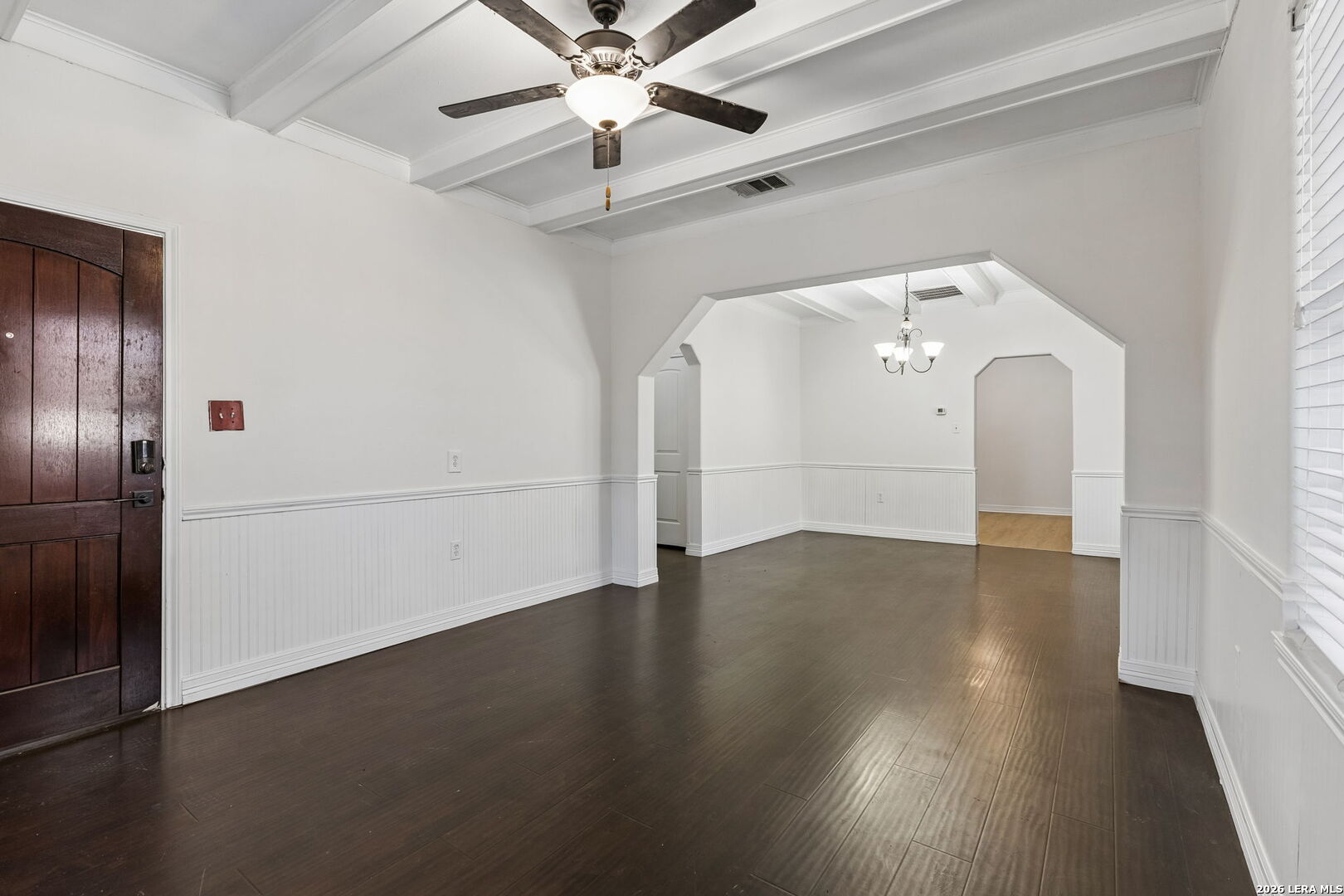438 Rigsby Avenue San Antonio, TX 78210 - Photo 5 of 25 an empty room with wooden floor fan and windows