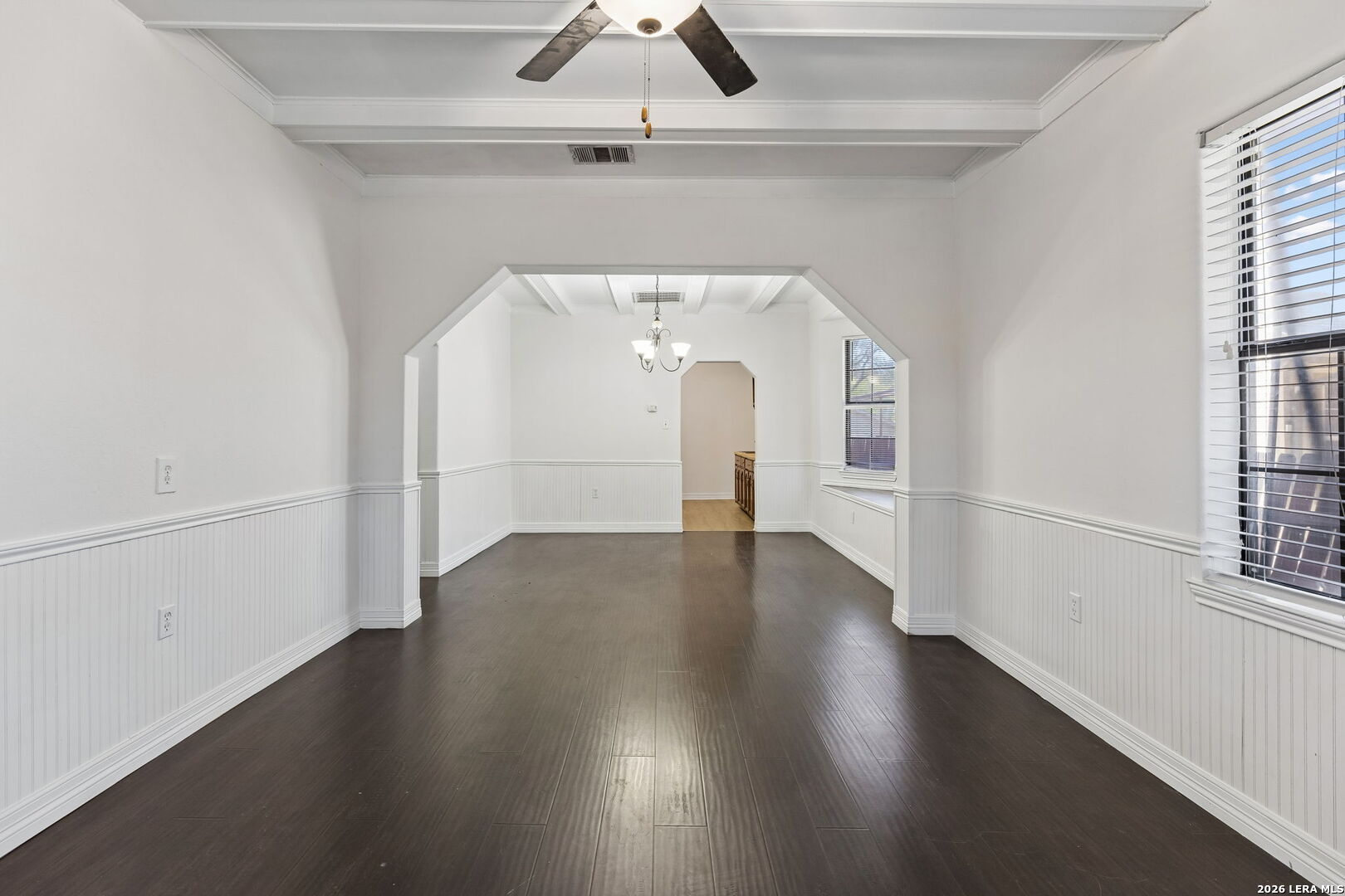 438 Rigsby Avenue San Antonio, TX 78210 - Photo 6 of 25 wooden floor in an empty room with a window