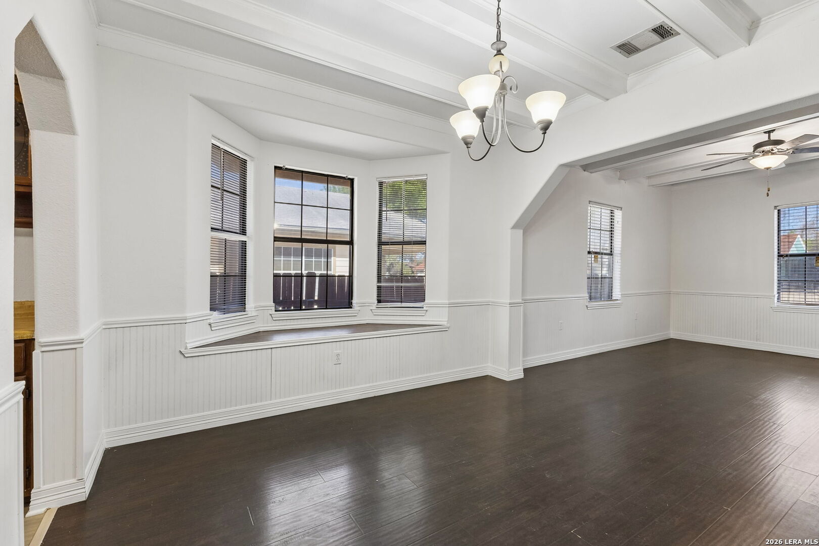 438 Rigsby Avenue San Antonio, TX 78210 - Photo 8 of 25 an empty room with wooden floor and windows