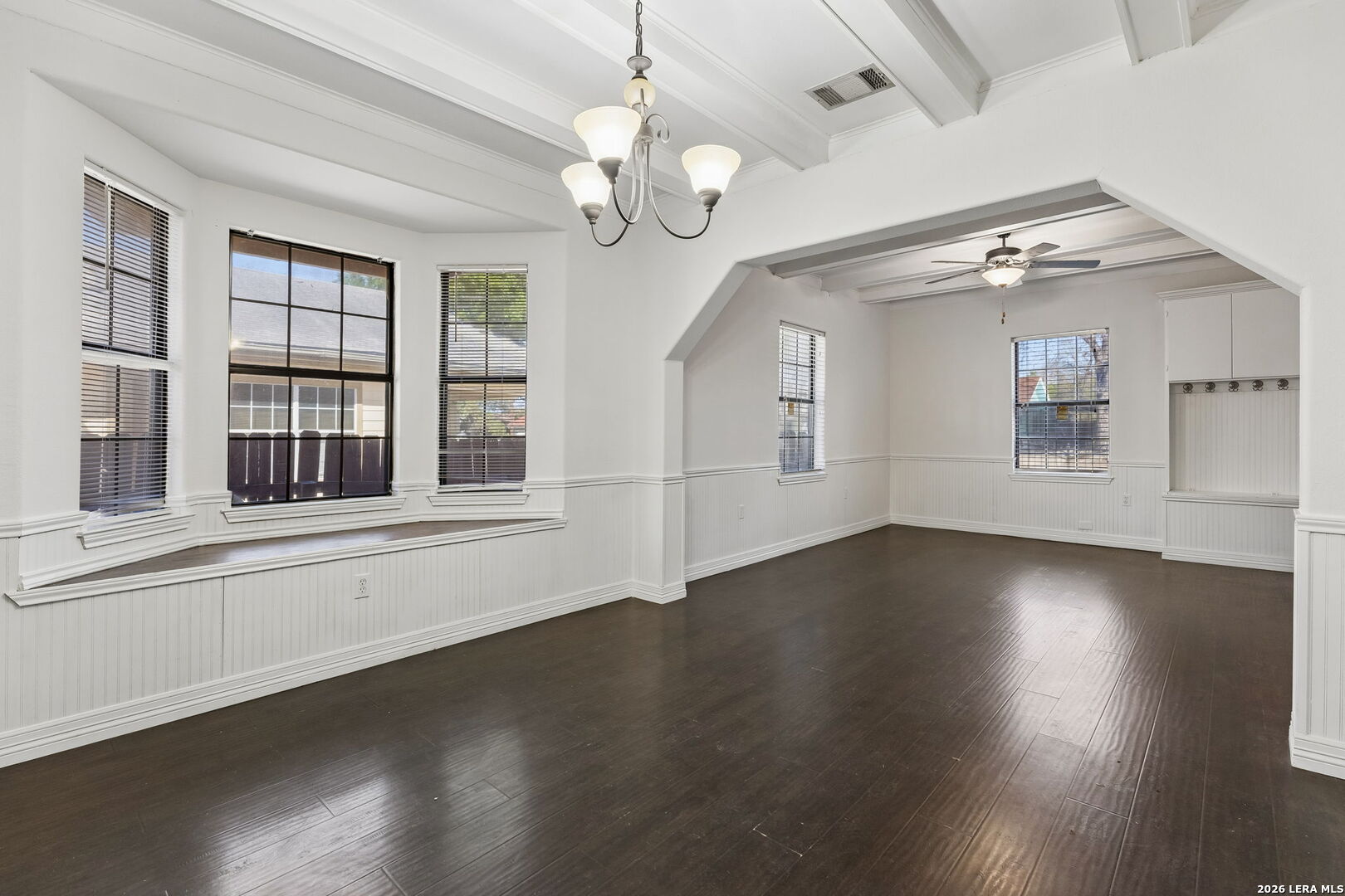 438 Rigsby Avenue San Antonio, TX 78210 - Photo 9 of 25 a view of an empty room with wooden floor and a window