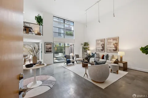 a living room with furniture gym equipment and a floor to ceiling window