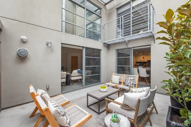 a backyard of a house with table and chairs