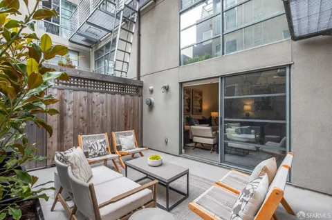 a view of kitchen with refrigerator stove dining table and chairs