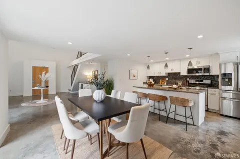 a view of a dining room with furniture and a potted plant