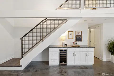 a bathroom with a granite countertop sink a mirror and a shower
