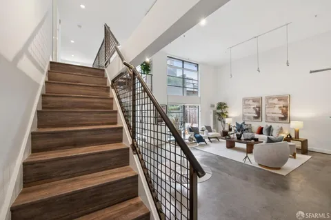 a bedroom with a bed a window and potted plant on the dresser