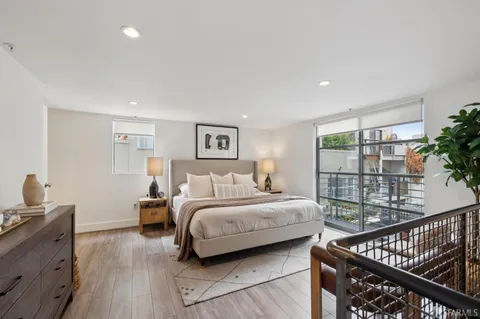 a bedroom with a bed and a painting on the wall