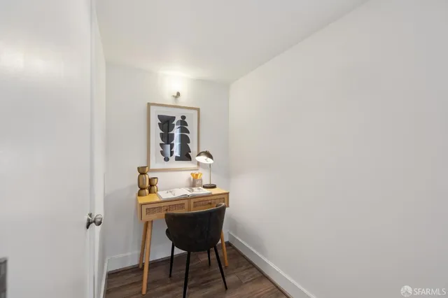 a bedroom with a bed and a painting on the wall