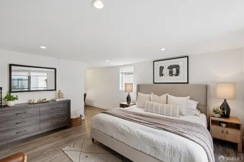 a bedroom with a large bed and a window