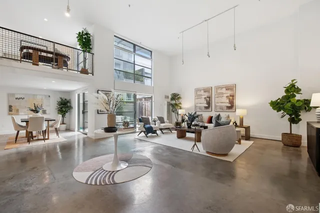a living room with furniture potted plant and a chandelier