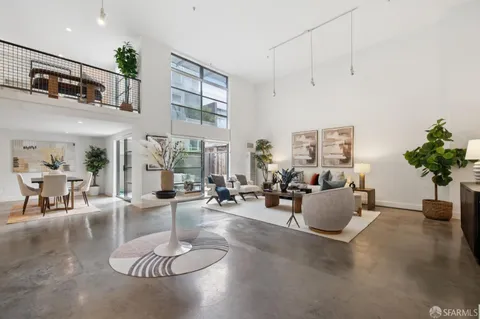a living room with furniture potted plant and a chandelier