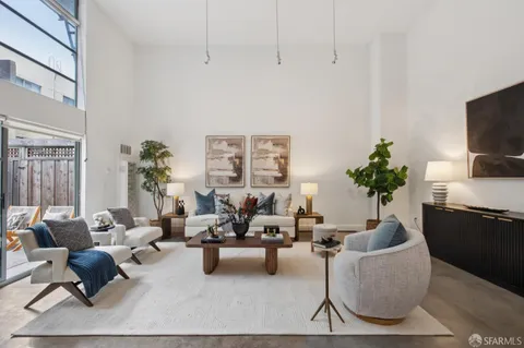 a living room with furniture potted plant and a window