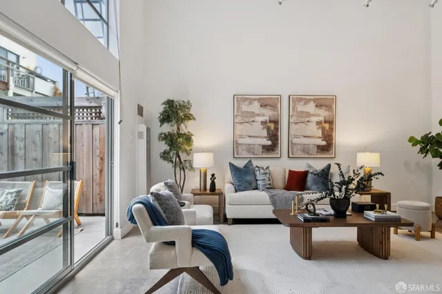 a living room with furniture and a potted plant