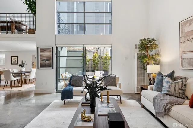 a living room with furniture flowerpot and wooden floor