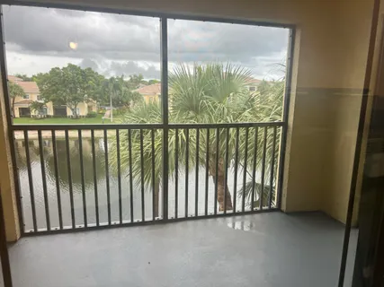 a view of a balcony with floor to ceiling window and stairs