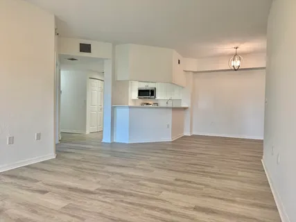 a view of a kitchen with a sink and a refrigerator