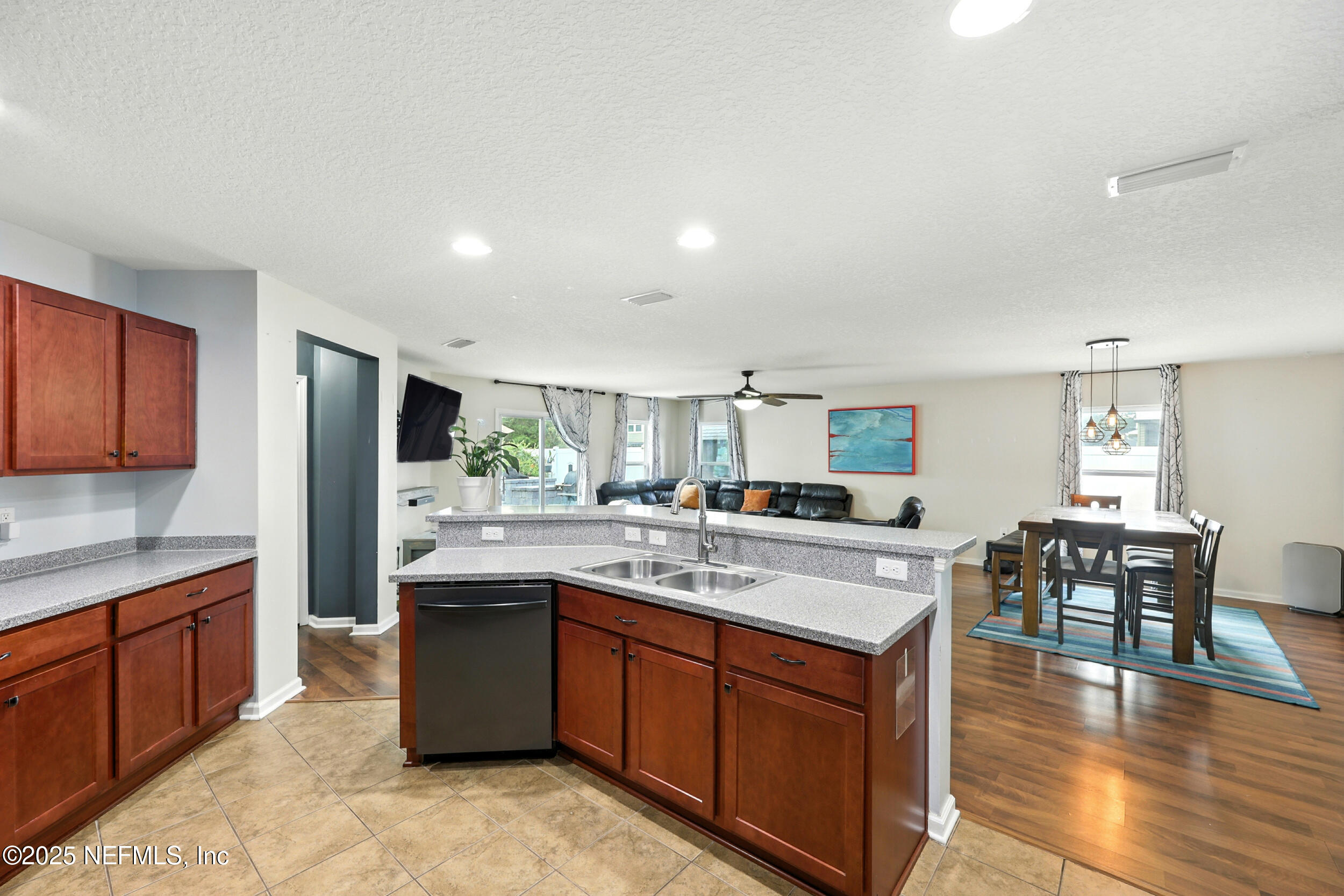 76866 Timbercreek Boulevard Yulee, FL 32097 - Photo 14 of 33 a kitchen with stainless steel appliances granite countertop a stove top oven a sink dishwasher and white cabinets with wooden floor