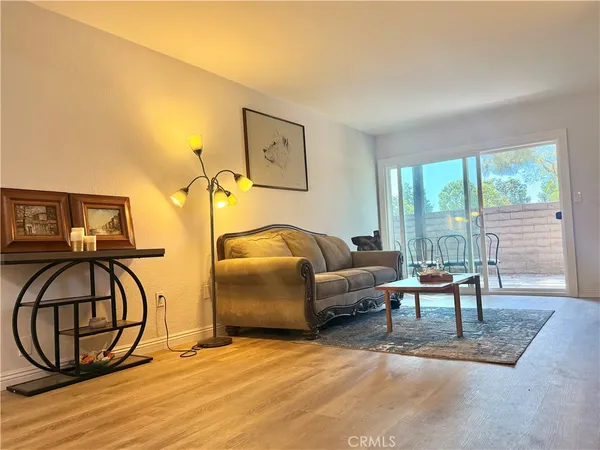 a living room with furniture and a floor to ceiling window