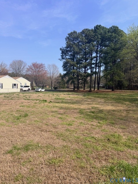 7387 Colts Neck Road Mechanicsville, VA 23111 - Photo 7 of 7 a view of a yard with trees in the background