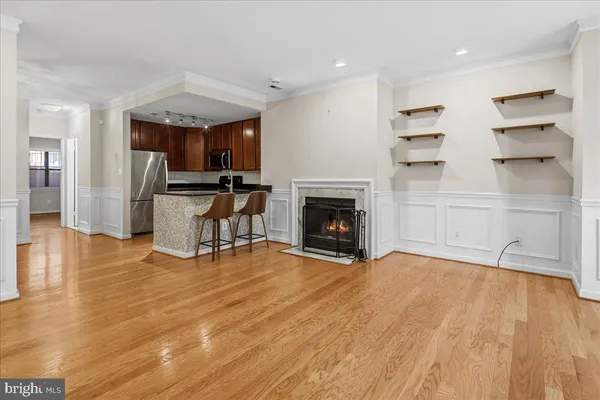 a view of empty room with wooden floor and fireplace