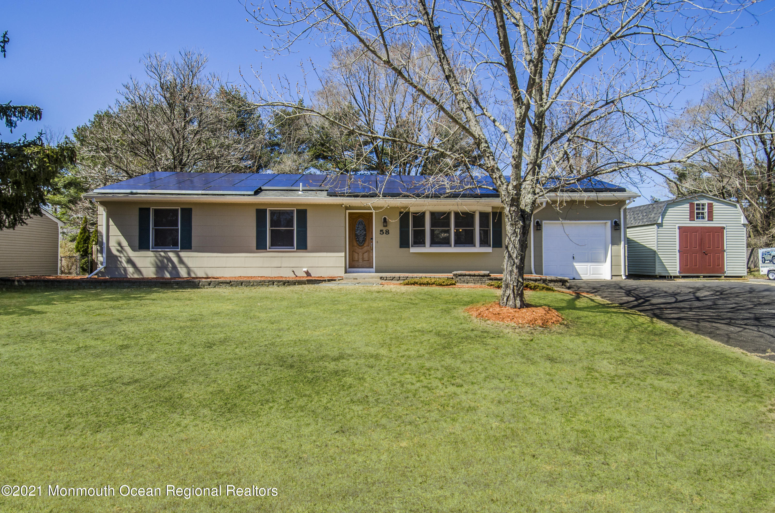 58 Pinewood Drive Brick, NJ 08724 - Photo 2 of 30 a front view of house with yard and seating area