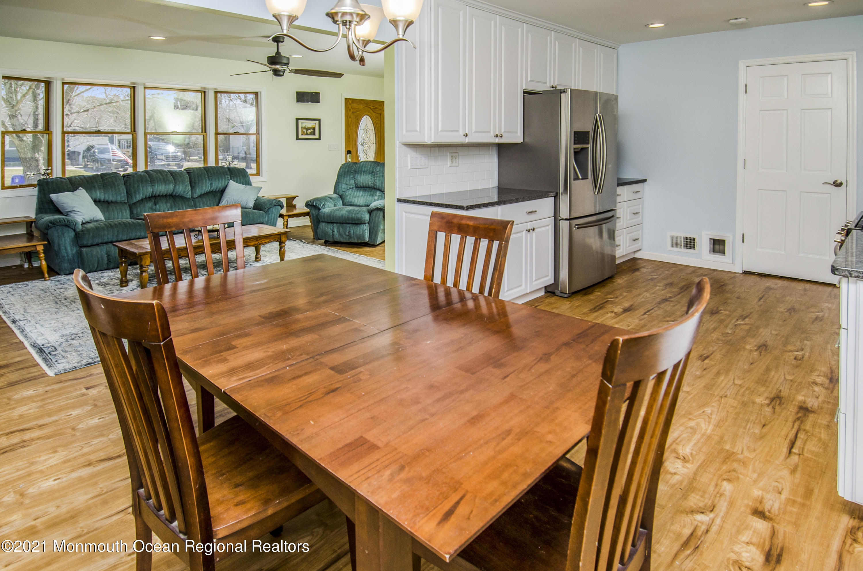 58 Pinewood Drive Brick, NJ 08724 - Photo 12 of 30 a kitchen with stainless steel appliances kitchen island granite countertop a refrigerator a stove a dining table and chairs with wooden floor
