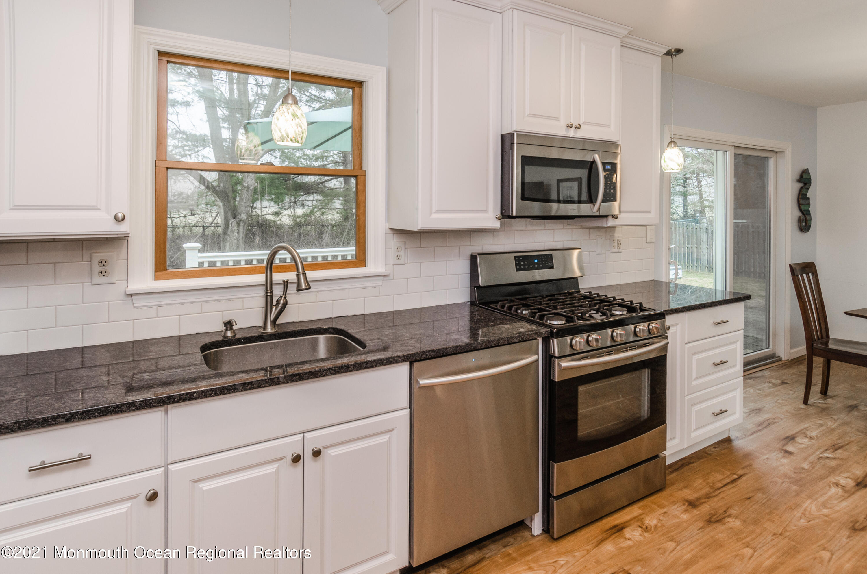 58 Pinewood Drive Brick, NJ 08724 - Photo 17 of 30 a kitchen with granite countertop a stove a sink and a microwave