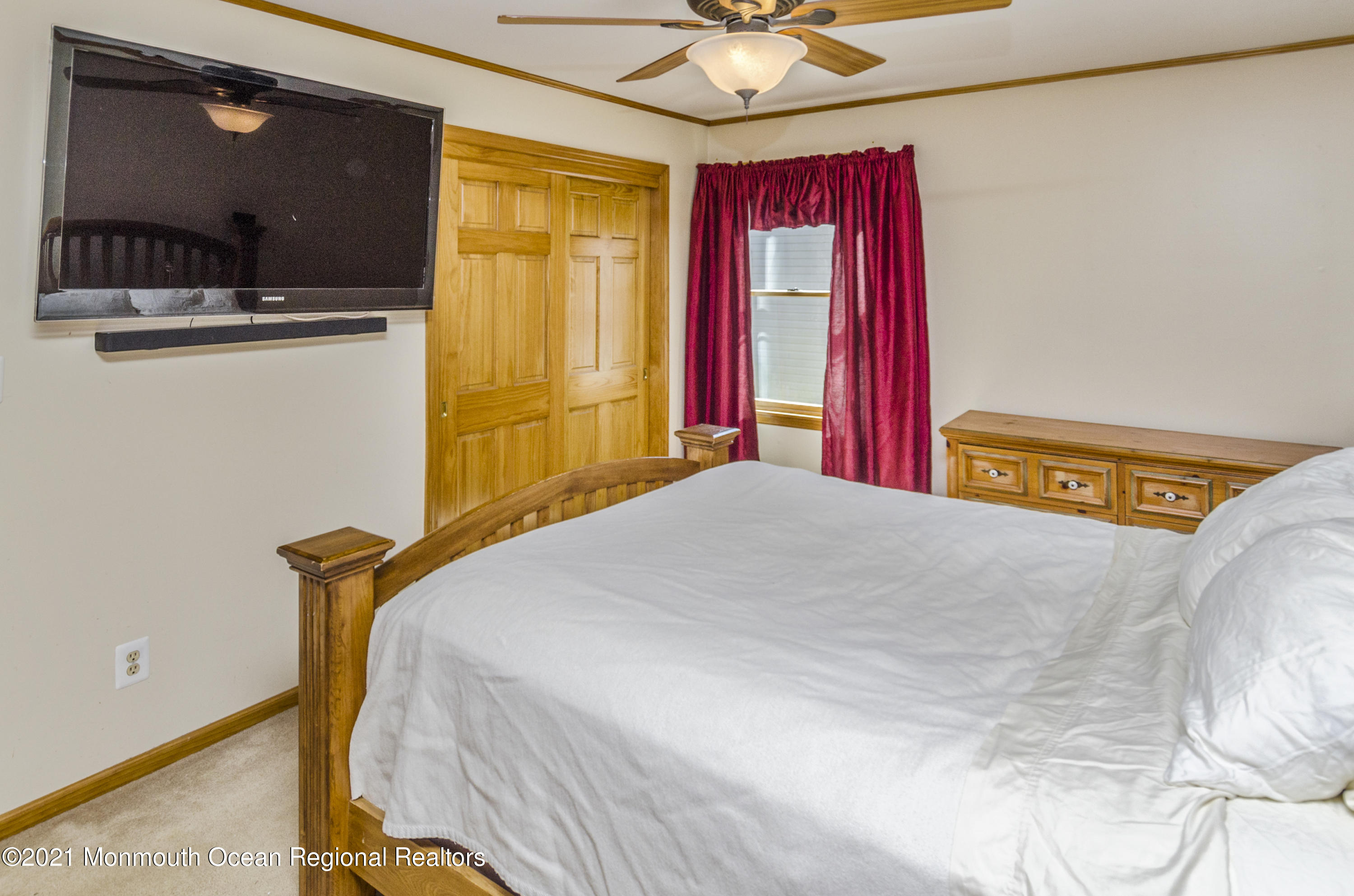 58 Pinewood Drive Brick, NJ 08724 - Photo 18 of 30 a bedroom with a bed and a chandelier