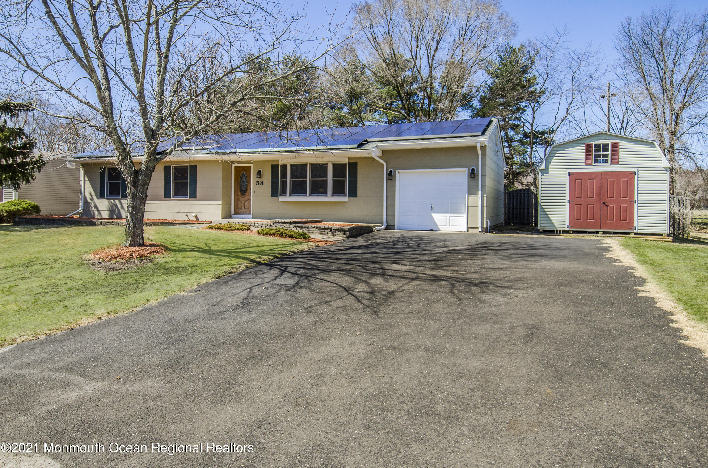 58 Pinewood Drive Brick, NJ 08724 - Photo 3 of 30 a front view of a house with a yard and garage