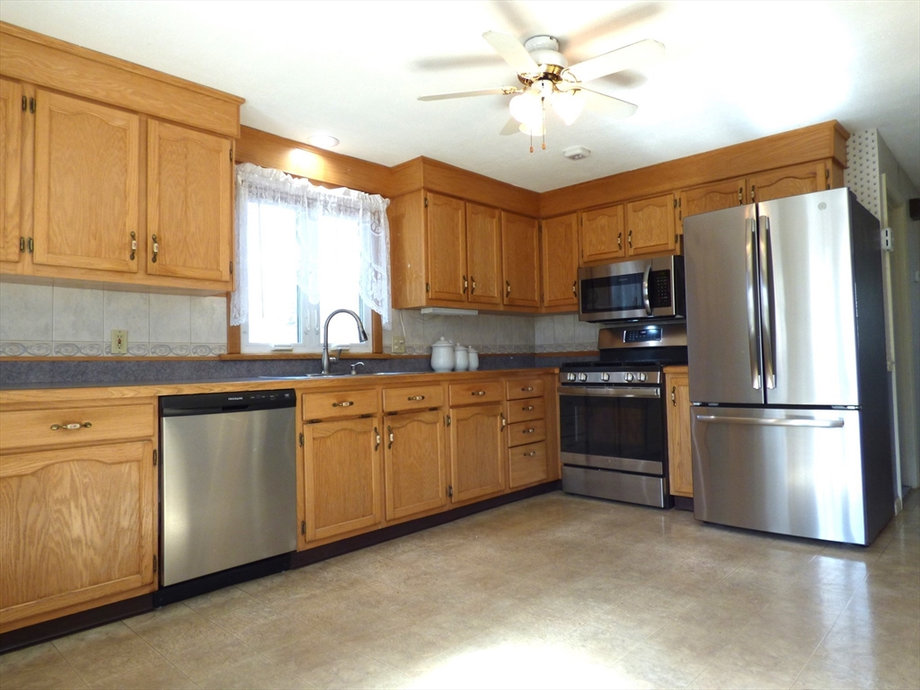 92 Wrentham Road Springfield, MA 01119 - Photo 8 of 29 a kitchen with kitchen island a sink appliances and cabinets
