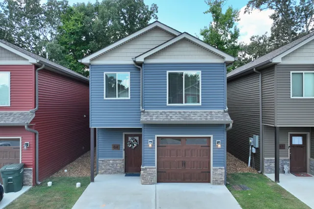 a front view of a house with garage