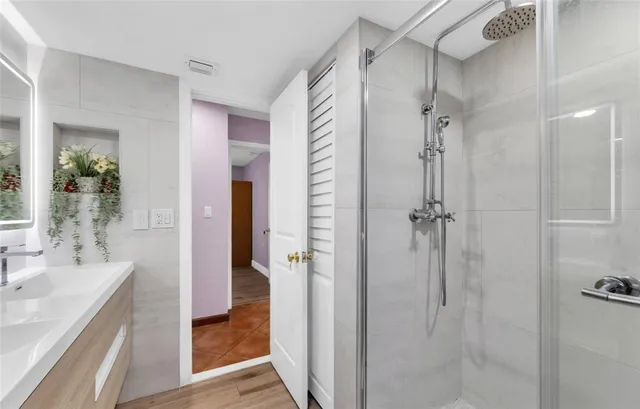 a bathroom with a shower and a sink