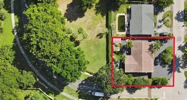 an aerial view of a house with a yard and garden