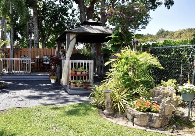 a view of a porch with furniture and a yard