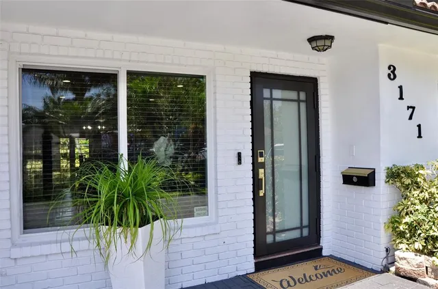 front view of a house with a potted plant