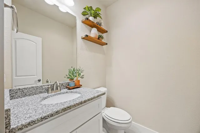 a kitchen with appliances a sink and cabinets