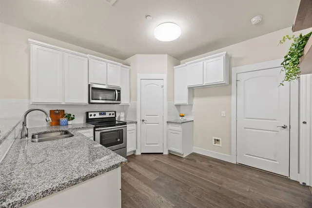 a kitchen with a white cabinets and white appliances