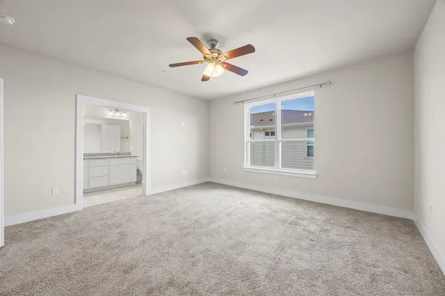 a bathroom with a granite countertop sink a toilet a bathtub and vanity