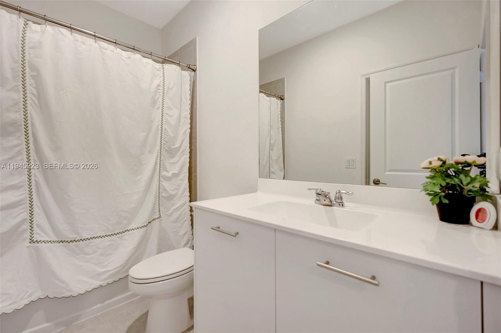 2455 Northwest 119th Street Miami, FL 33167 - Photo 15 of 38 a bathroom with a sink a toilet and a mirror