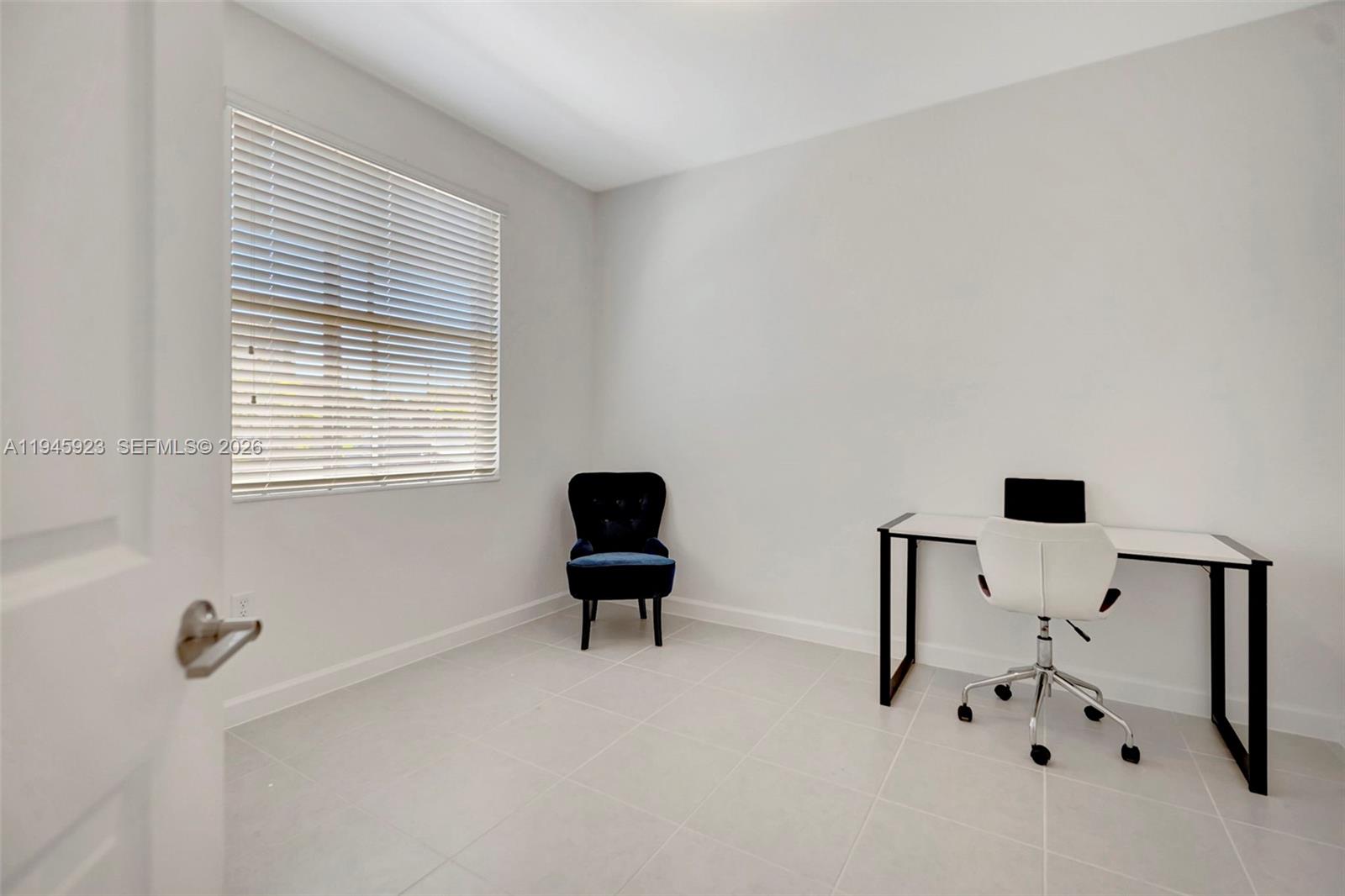 2455 Northwest 119th Street Miami, FL 33167 - Photo 17 of 38 a bedroom with a bed and a window