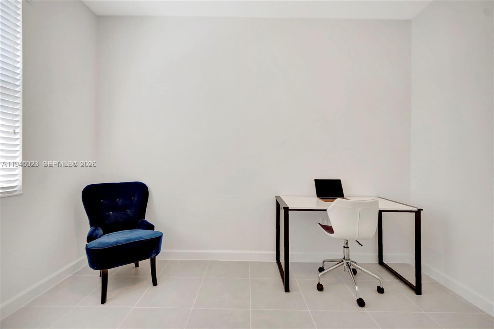 2455 Northwest 119th Street Miami, FL 33167 - Photo 18 of 38 a chair and a table in a room