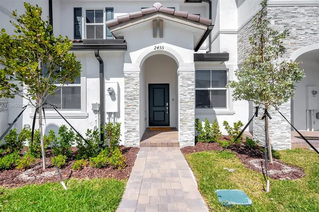 a front view of a house with garden