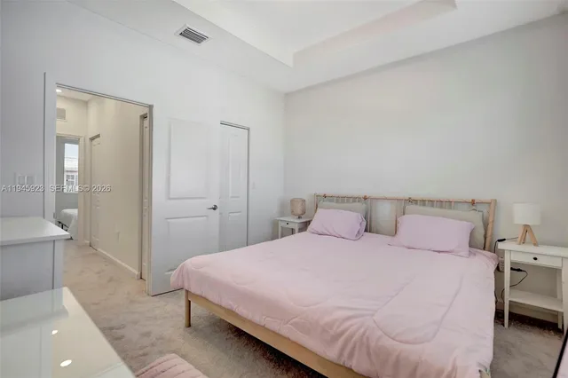 a bedroom with a bed and a couch