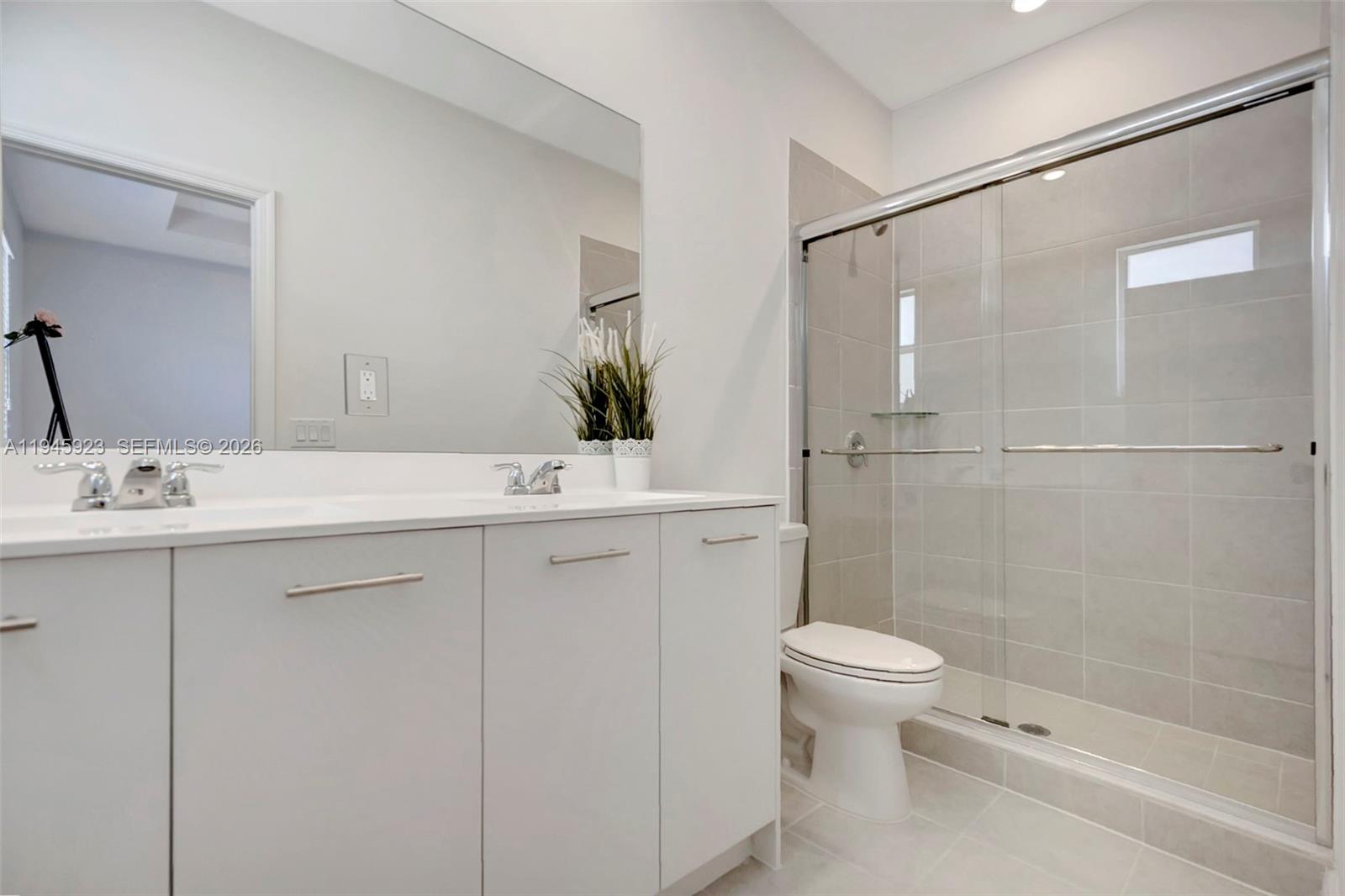 2455 Northwest 119th Street Miami, FL 33167 - Photo 25 of 38 a bathroom with a sink toilet and shower