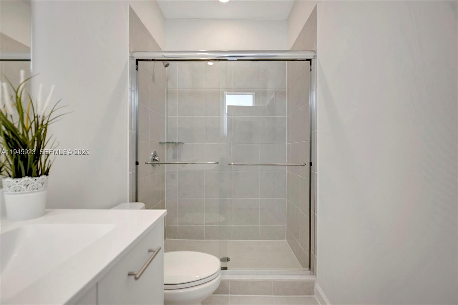 2455 Northwest 119th Street Miami, FL 33167 - Photo 26 of 38 a bathroom with a shower a toilet and a sink